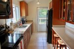 Well equipped galley style kitchen with dishwasher and garbage disposal
